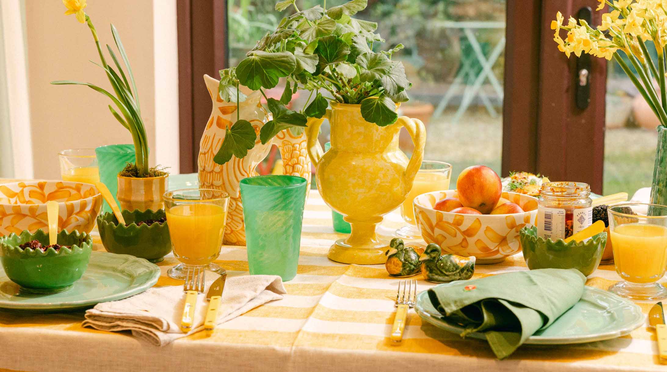 Decorative table setting with colourful tableware and fresh fruits. LAMP LDN LIVING
