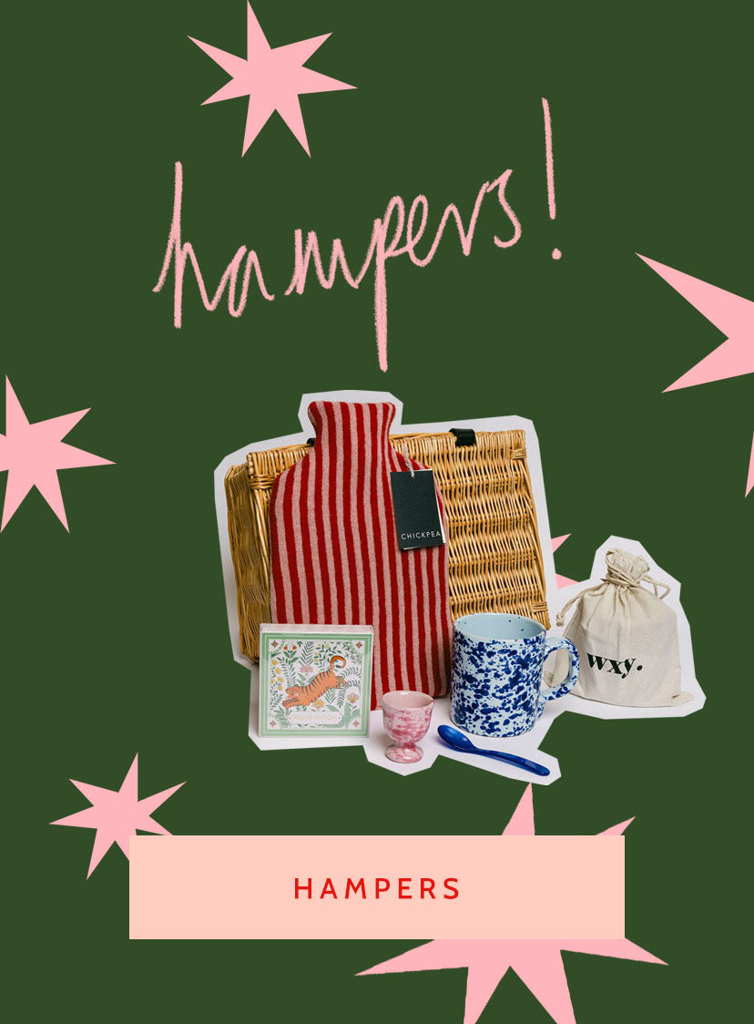 Gift hamper with items on a green background with pink stars and 'Hampers!' text. LAMP LDN LIVING